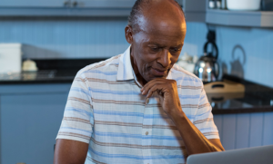 man considering medicare options on computer