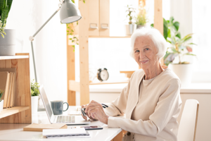 Woman on computer learning 2023 Medicare changes