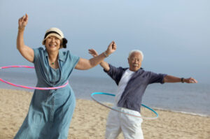 hula hooping senior couple learning about types of Medicare plans