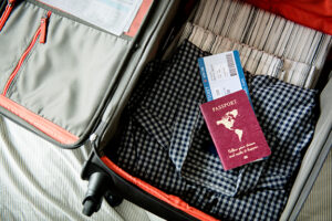 passport and ticket inside of a suitcase being packed for a senior citizen on Medicare who is going on vacation