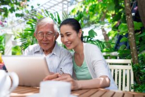 senior getting help looking for resources online to afford Medicare costs